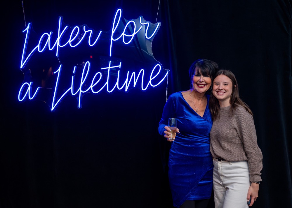 President Mantella with a girl in white pants and brown shirt